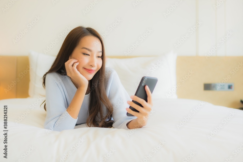 Portrait beautiful young asian woman use smart mobile phone on bed Portrait beautiful young asian woman use smart mobile phone on bed