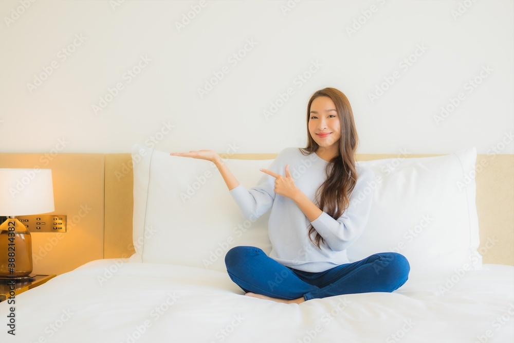 Portrait beautiful young asian woman smile relax leisure on bed