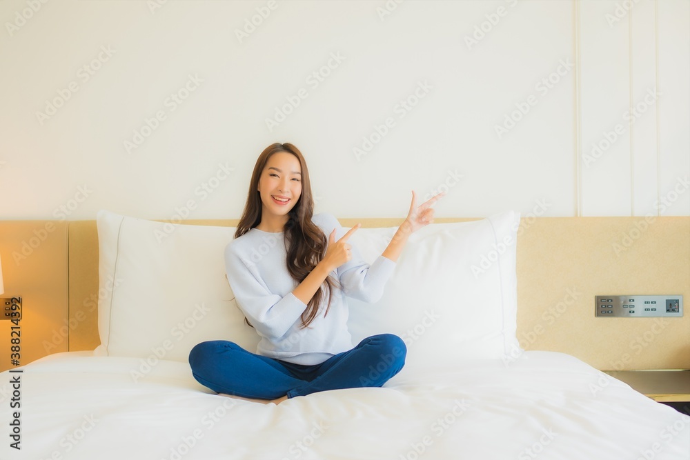 Portrait beautiful young asian woman smile relax leisure on bed