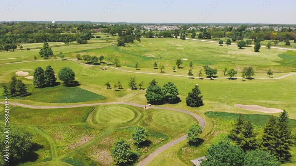 Aerial View from the top n of the golf course. People and cars on a golf course from a height. Aerial View from the top n of the golf course. People and cars on a golf course from a height.