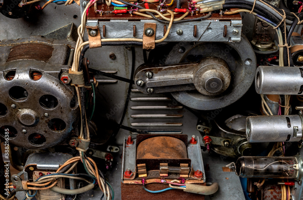 The internal mechanism of an old reel tape recorder with vacuum tubes