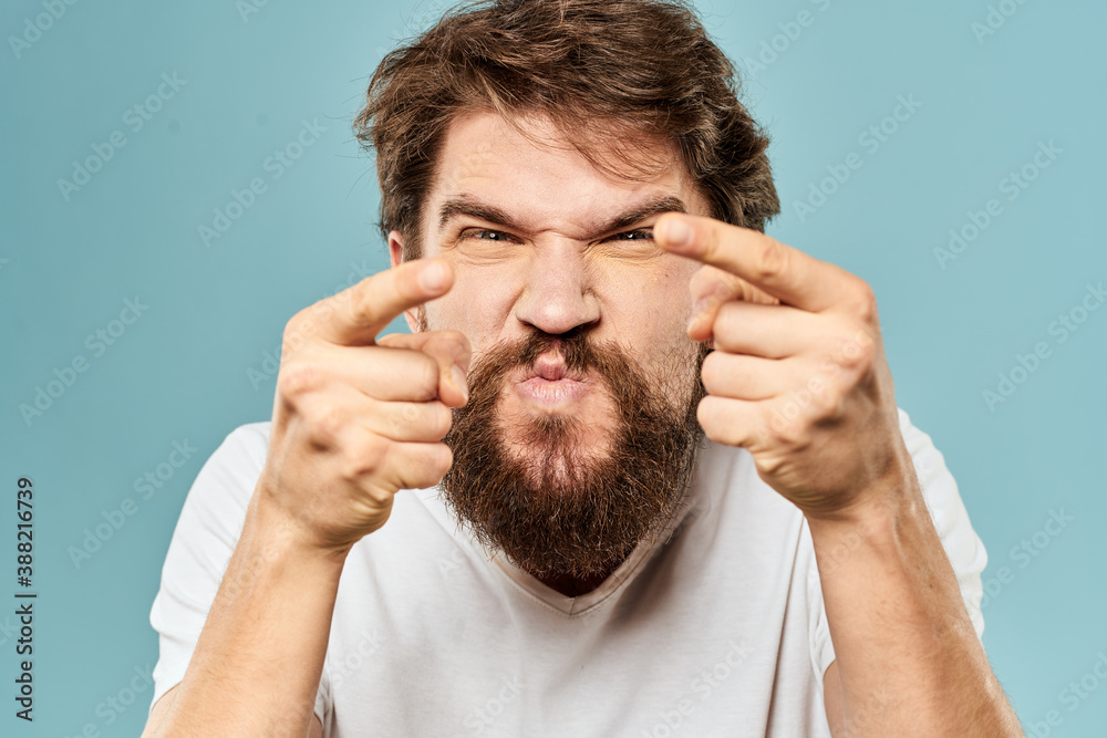 Bearded man emotions facial expression gestures hands close-up blue background