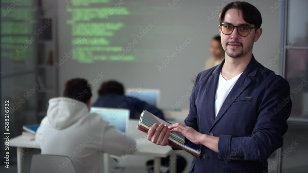custom made wallpaper toronto digitalMedium closeup of young modern IT teacher in glasses holding notebooks and papers looking at camera smiling in equipped classroom with students making report about coding in front of projector