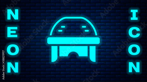 Photography Glowing neon Hockey helmet icon isolated on brick wall background