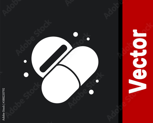 White Medicine pill or tablet icon isolated on black background. Capsule pill and drug sign. Pharmacy design. Vector.