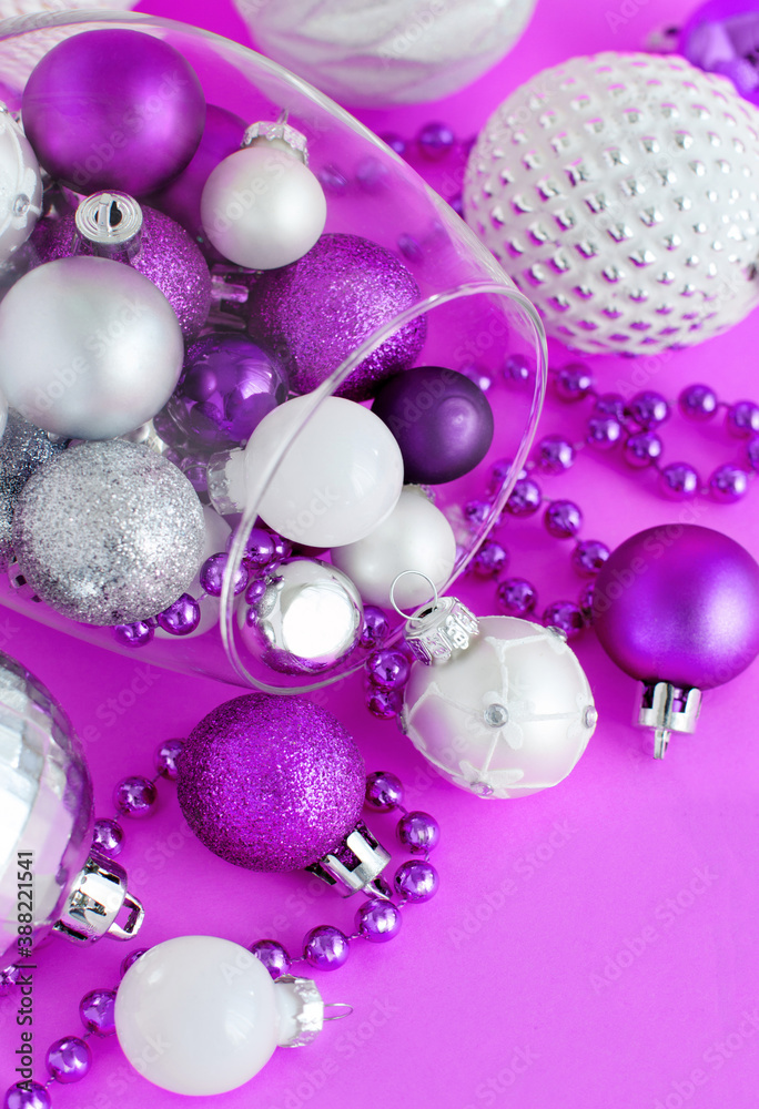 Christmas baubles in a wine glass on a purple background Christmas baubles in a wine glass on a purple background