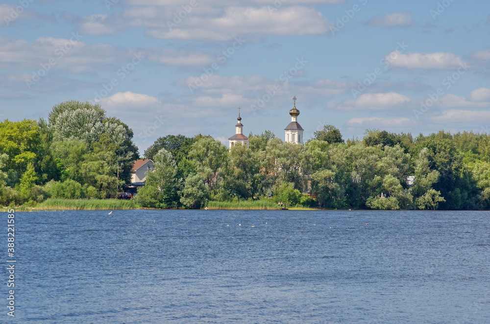 View from lake Seliger to the Zhitny Peninsula and the Church of John the theologian and Andrew the first-called in the Bogoroditsky Zhitny convent. The city of Ostashkov, Tver oblast, Russia