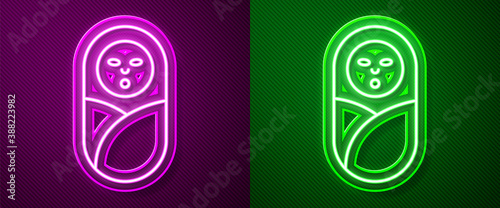 Glowing neon line Newborn baby infant swaddled or swaddling icon isolated on purple and green background. Baby kid child wrapped in blanket clothes. Vector.