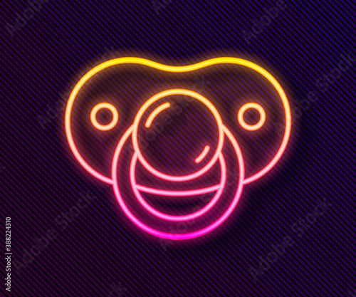 Glowing neon line Baby dummy pacifier icon isolated on black background. Toy of a child. Vector.