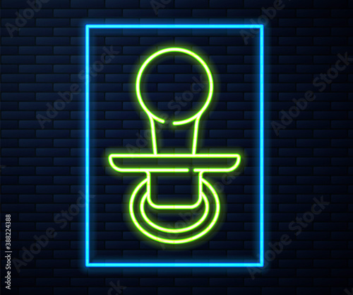Glowing neon line Baby dummy pacifier icon isolated on brick wall background. Toy of a child. Vector.