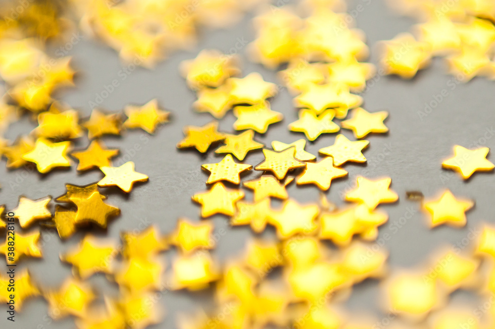 Color confetti in the shape of stars on a white paper background. Universal template for cards, greetings. Holographic lilac sequins. Macro photo with natural light, bokeh. Color confetti in the shape of stars on a white paper background. Universal template for cards, greetings. Holographic lilac sequins. Macro photo with natural light, bokeh.