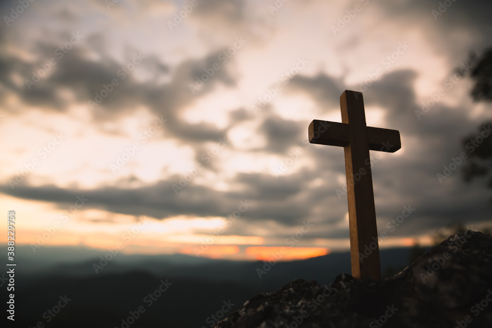 Religious concepts. Christian wooden cross on a background with dramatic lighting,  Jesus Christ cross, Easter, resurrection concept. Christianity, Religion copyspace background.