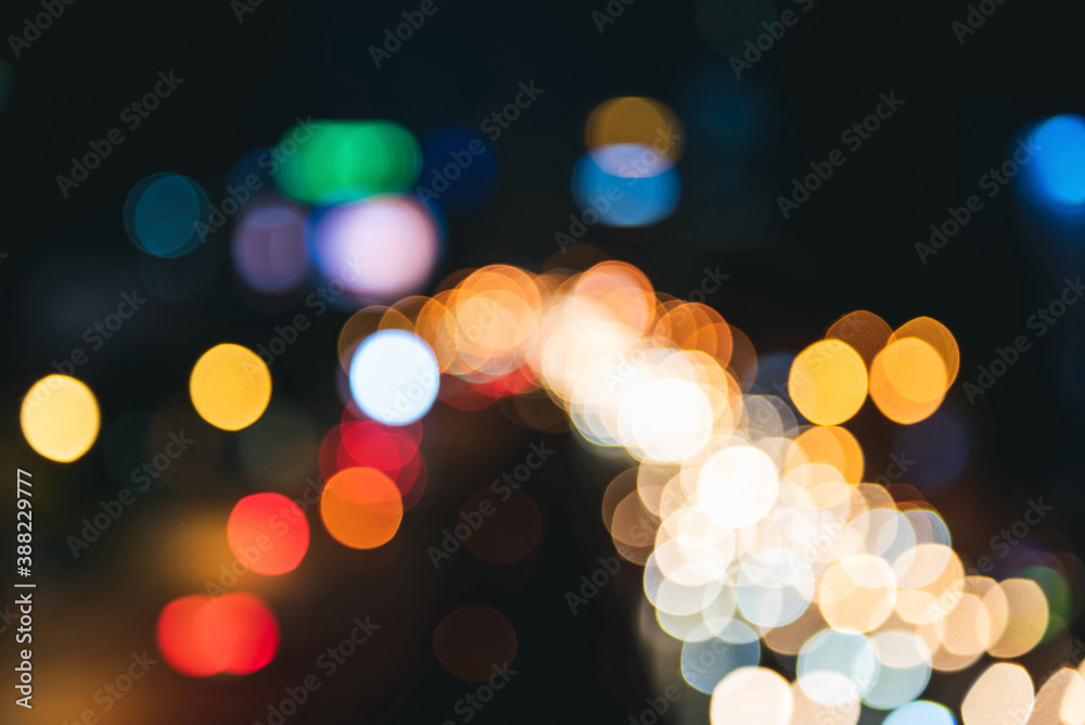 Blurred street view of city at night with vibrant bokeh light on dark background Blurred street view of city at night with vibrant bokeh light on dark background