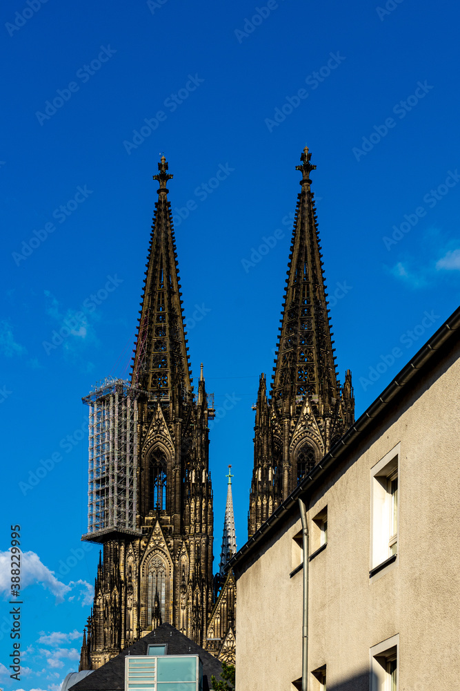 Germany, Cologne, a large tall tower with a clock at the top of a building