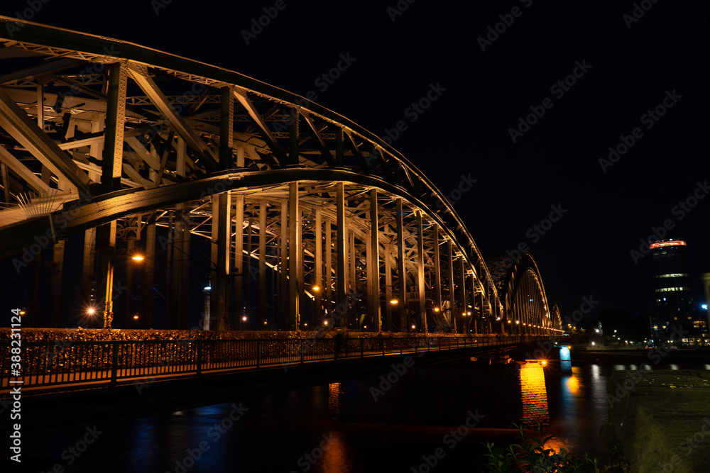 Germany, Cologne, a large bridge lit up at night