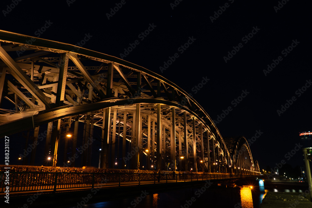 Naklejka premium Germany, Cologne, a large bridge lit up at night