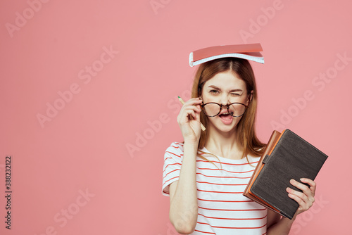 Tableau sur toile beautiful female student holding books education institute gesturing with hands