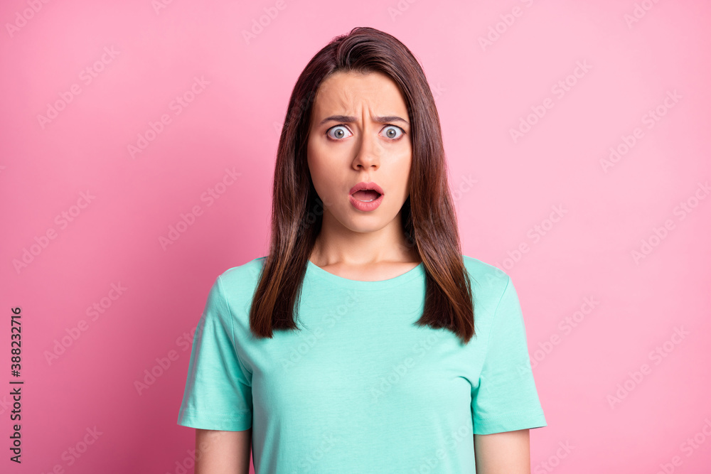 Portrait photo of shocked troubled young woman starring with opened mouth isolated on pastel pink color background Portrait photo of shocked troubled young woman starring with opened mouth isolated on pastel pink color background