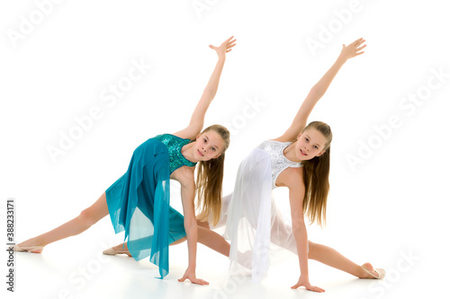 Pretty Girls Gymnasts Performing Rhythmic Gymnastics Exercise.