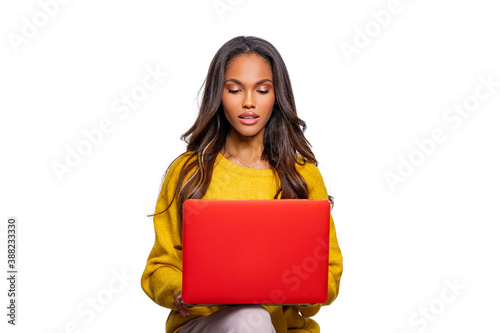 Image of cheerful African American woman using laptop. Isolated. Person and Laptop.   photo