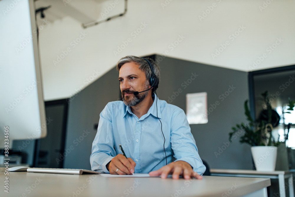 Man reading news online, taking break from work.