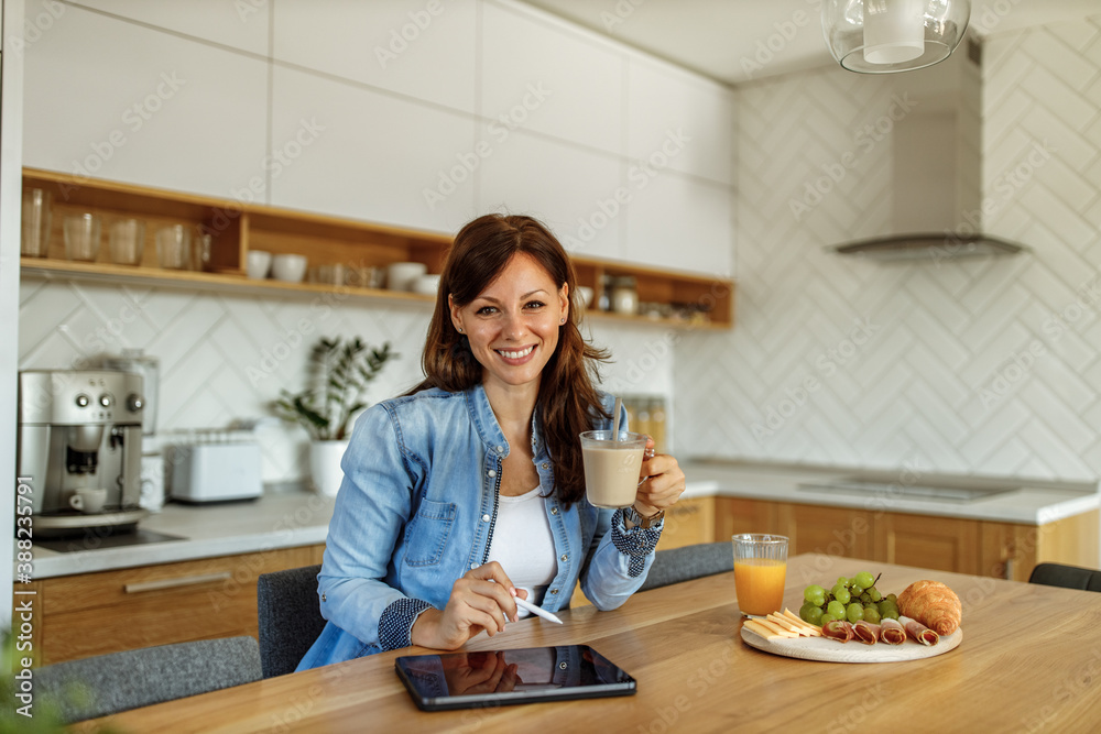 Using modern technology, working from kitchen desk. Using modern technology, working from kitchen desk.