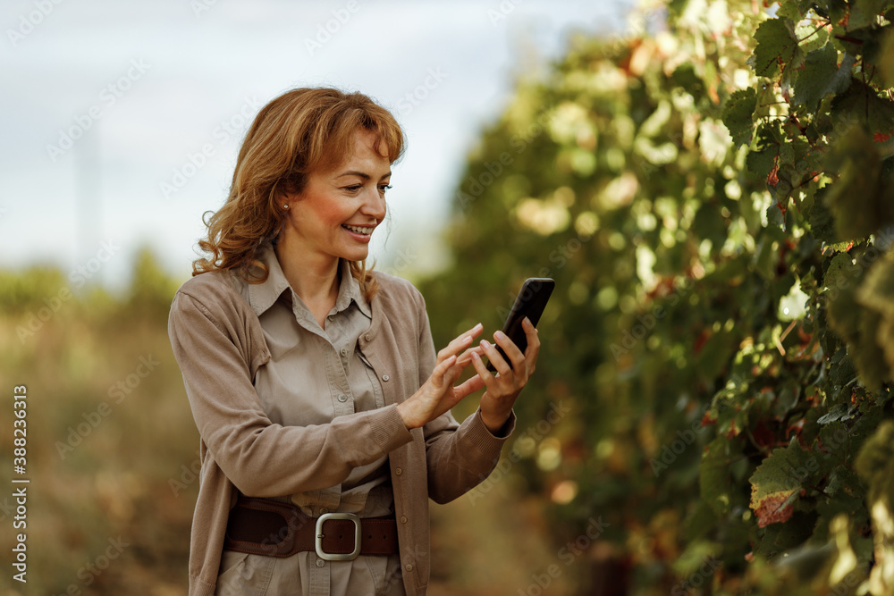 Dressed casually, green background.