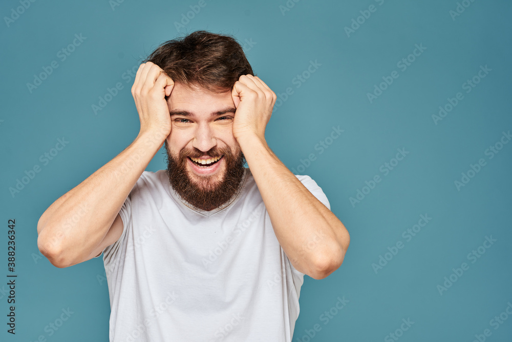emotional man gesturing with hands lifestyle fun white t-shirt blue isolated stock emotional man gesturing with hands lifestyle fun white t-shirt blue isolated stock