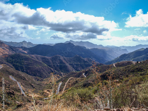 Landscape of Gran Canaria with curvy road  mountains  valleys  clouds at Canary Islands  Spain  no people 