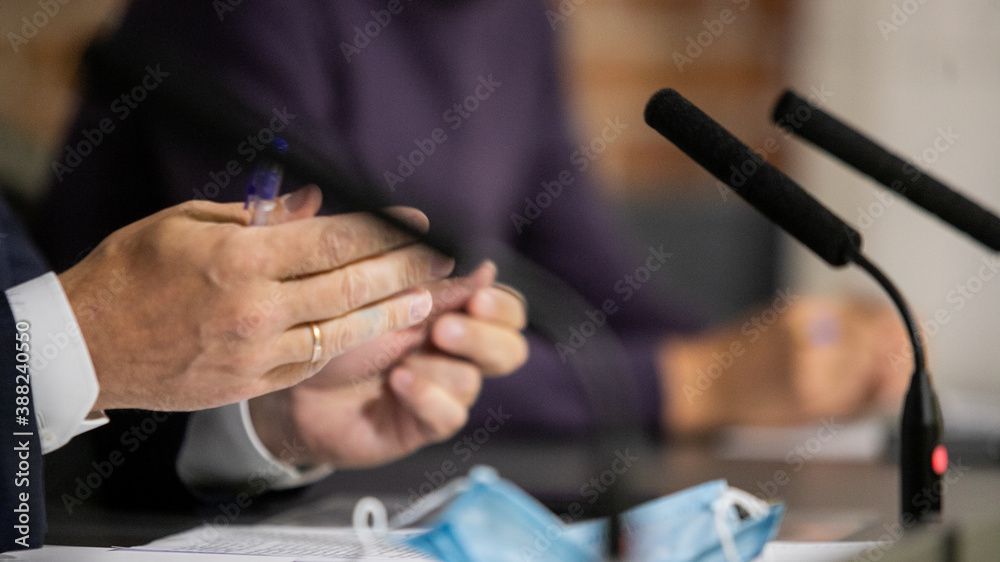 Fototapeta premium Press conference. Public speaker giving talk to Television camera. News conference. An event with a video camera. press and media in public news coverage event for reporter and mass communication