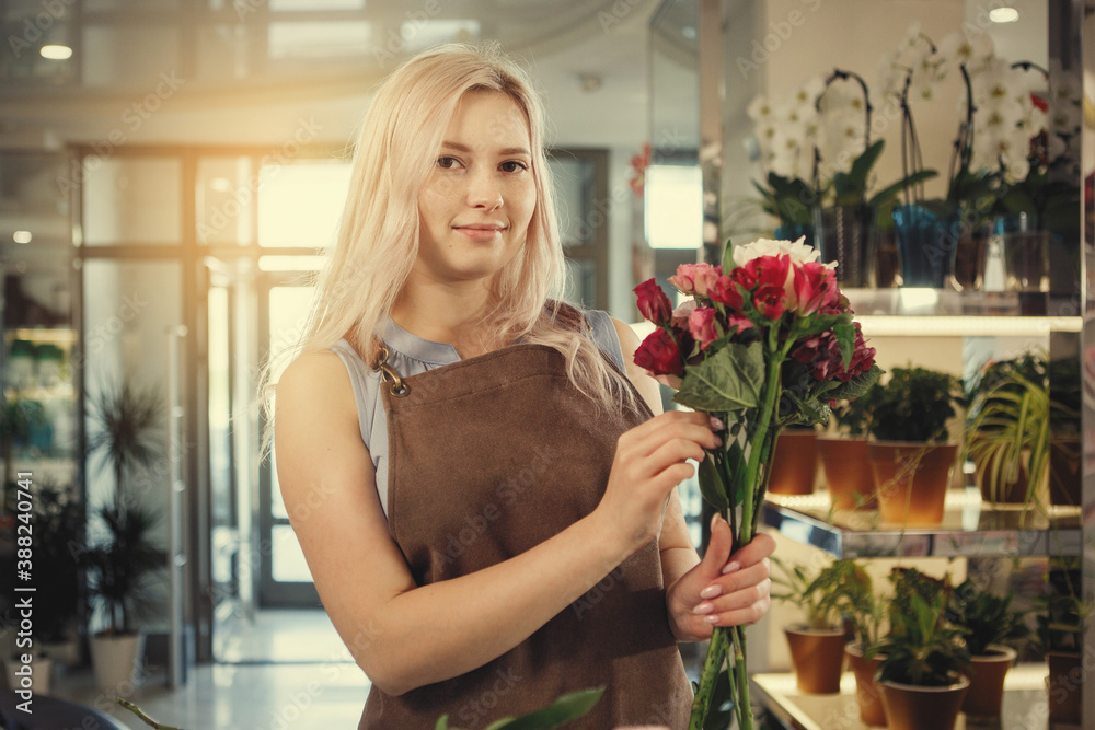 Woman florist collects a bouquet Woman florist collects a bouquet