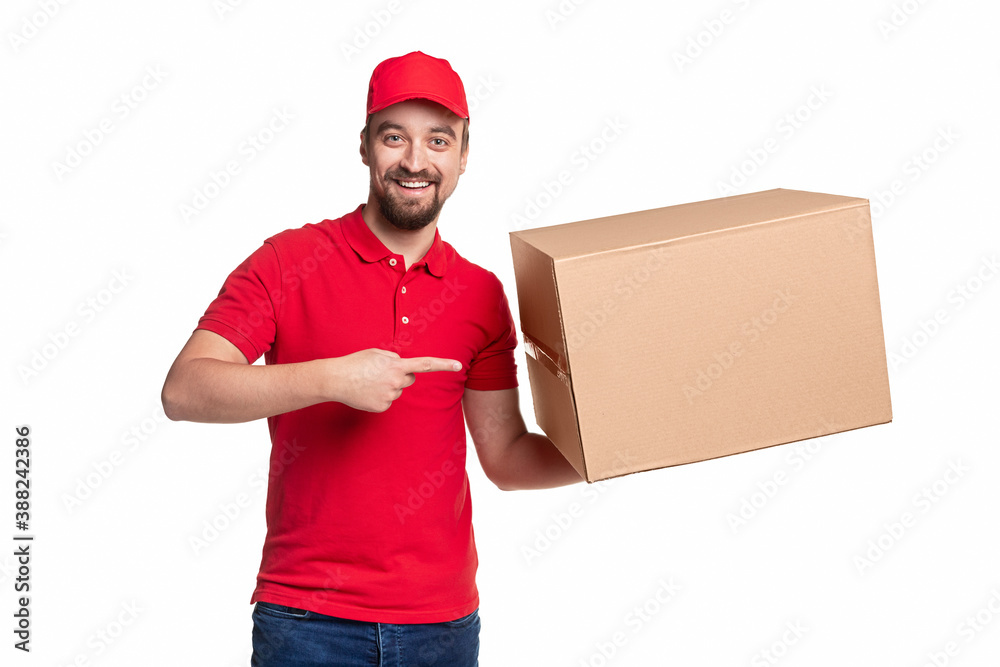 Cheerful delivery man pointing at box Cheerful delivery man pointing at box