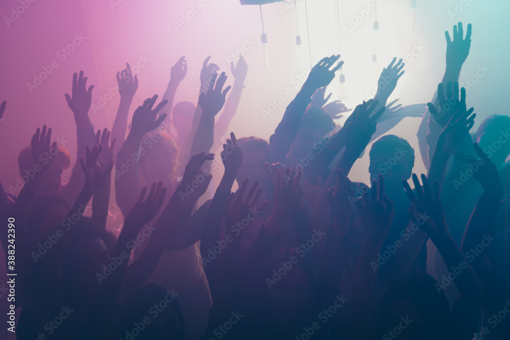 Photo of big group gather concert many funny people raise arms neon bright spotlight modern club indoors