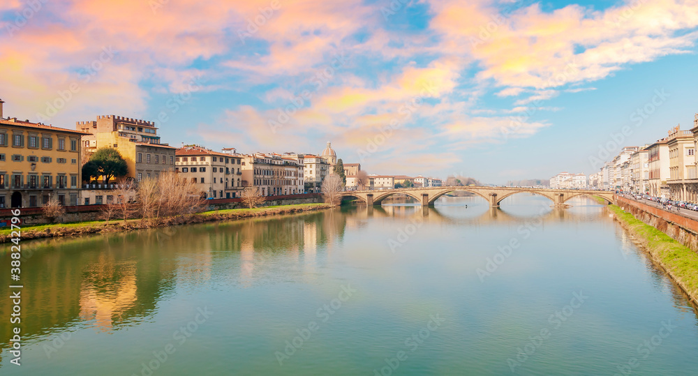 Panorama of the Arno river and the Holy Trinity Bridge under a beautiful sky, in Florence in Tuscany, Italy
