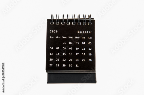 2020 DECEMBER. Time planning, business, day counting and holidays. Paper calendar on a white table