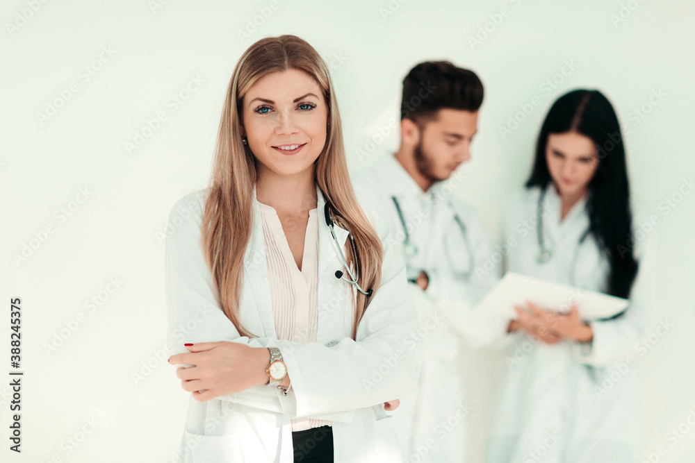 serious therapist with a clipboard while standing in clinic serious therapist with a clipboard while standing in clinic