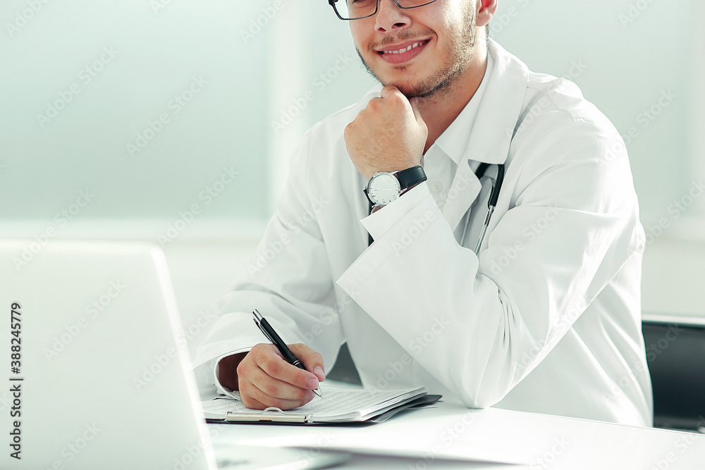 doctor therapist sitting at a table in his office doctor therapist sitting at a table in his office