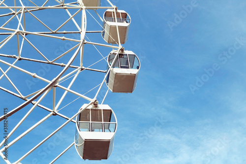 Valokuva Ferris wheel in an amusement Park against a blue sky