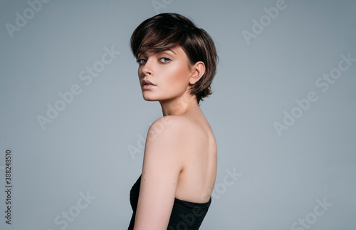 Portrait of a young beautiful brunette girl with stylish short hair