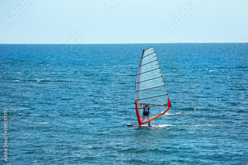 The man is engaged in windsurfing in the open sea. © Валерия Зеленева