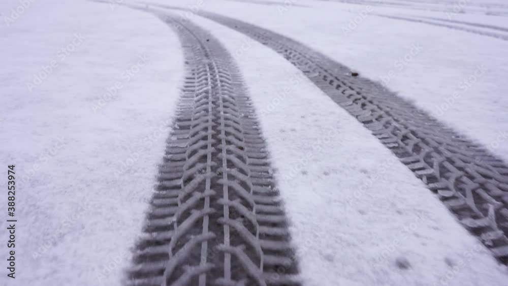 Snow covered road with tire tracks. The camera moves on the trail Snow covered road with tire tracks. The camera moves on the trail