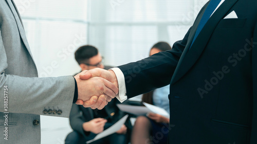 side view. serious business partners shaking hands © yurolaitsalbert