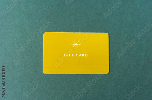 Gift card on green background. yellow gift card.