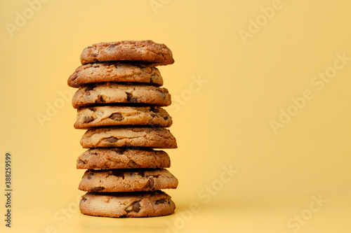 Canvas Print Pile of chocolate chip cookies on yellow backgreound