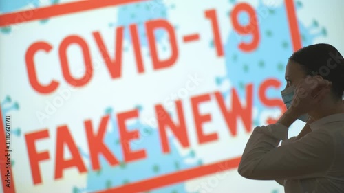 Beautiful girl puts on and takes off her mask, gets the latest information on the epidemic when she finishes the pandemic and lockdown, covid 19 fake news