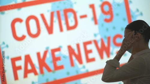 Beautiful girl puts on and takes off her mask, gets the latest information on the epidemic when she finishes the pandemic and lockdown, covid 19 fake news