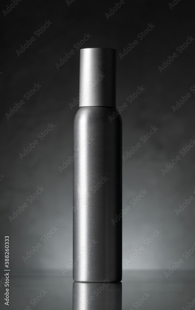 steel grey perfume container on a dark grey background. Concept. Minimalism steel grey perfume container on a dark grey background. Concept. Minimalism