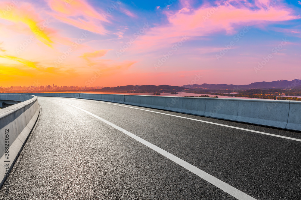 Fototapeta premium Asphalt viaduct road and city skyline in Hangzhou at sunset.