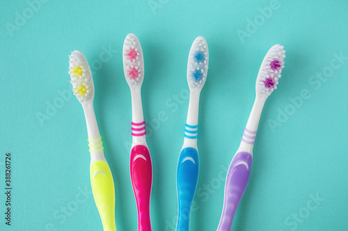 Toothbrushes for all family on blue background.