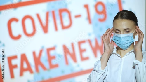 Beautiful girl puts on and takes off her mask, gets the latest information on the epidemic when she finishes the pandemic and lockdown, covid 19 fake news